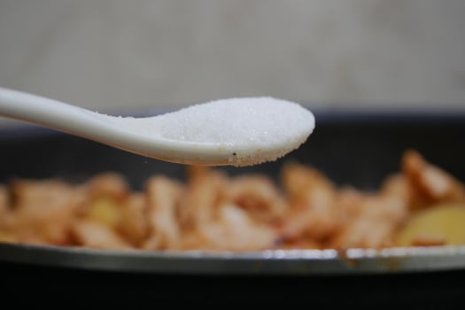 Cooking process with salt added to savory dish photo