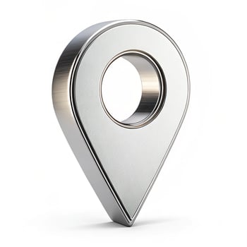 Silver location pin with textured surface and soft shadows photo