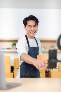 E-commerce Business Owner Preparing Packages for Shipment photo