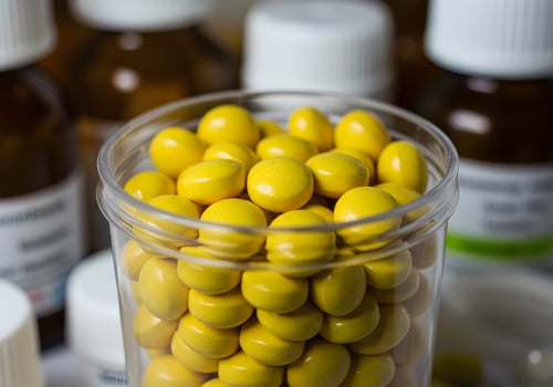A jar filled with yellow pills photo