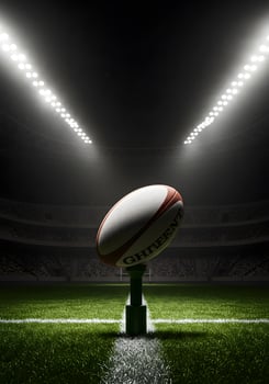 Rugby ball on the field with stadium lights photo