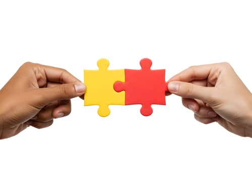 Two hands holding a red and yellow puzzle piece photo