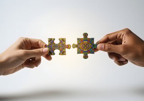 Two hands holding a puzzle piece together photo