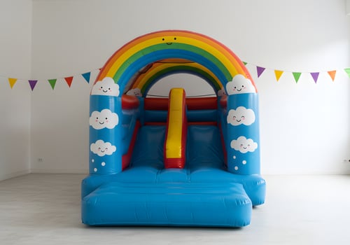 A bouncy castle with a rainbow and clouds photo