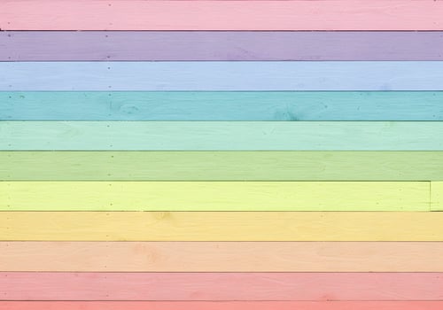 A rainbow colored wood panel background photo