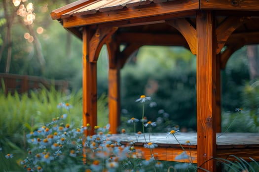 Wooden gazebo standing in a garden surrounded by flowers photo
