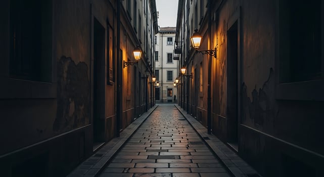 A narrow alley with street lights and a light photo