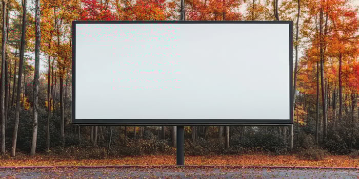 Blank billboard in autumn forest setting, perfect for advertising or promotions. photo