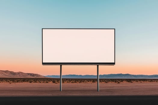 Empty billboard against a serene desert landscape at sunset. photo