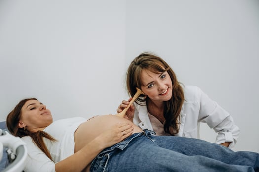 A woman is lying on a bed while a doctor is brushing her hair photo