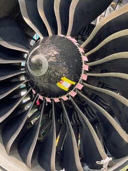 Close up of aircraft engine during overhaul inside airplane hangar photo