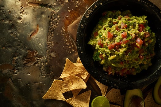 Fresh Guacamole and Tortilla Chips, a Delicious Mexican Snack. photo