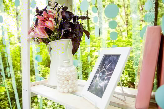 khabarovsk, russia, 28.08.2013 A white vase with pink flowers sits on a shelf next to a picture frame. photo