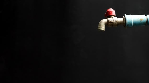 A blue and red water tap on a black background photo