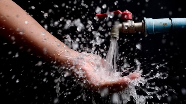 A person is washing their hands with water photo