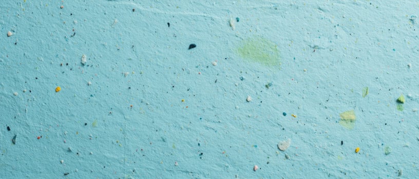 The vibrant blue textured surface with colorful speckles and artistic appeal. photo