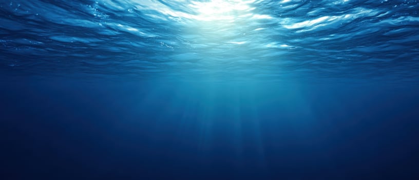 The tranquil underwater scene with sunlight illuminating the ocean depths. photo