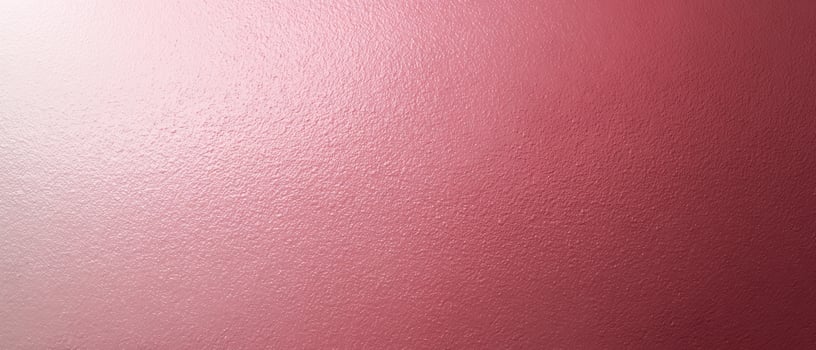 The smooth pink wall with subtle texture creating a warm ambiance. photo