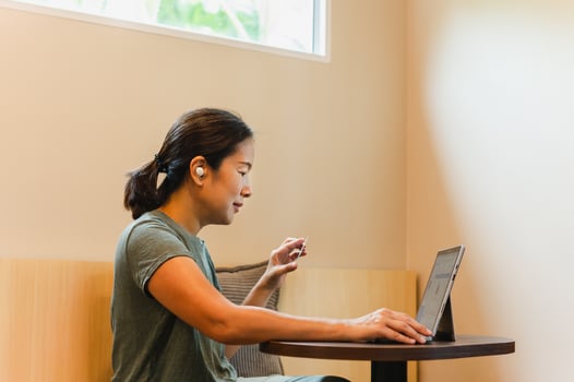 Asian woman working on laptop in cafe show her personal ID card. photo