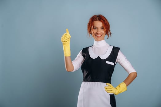 A woman in a maid outfit with yellow rubber gloves photo