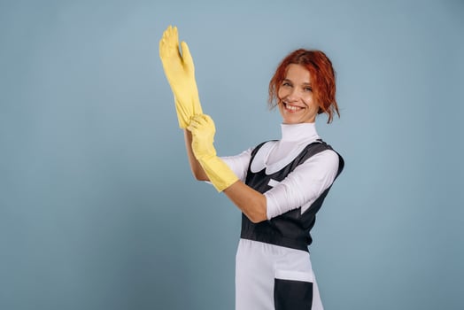 Woman with yellow cleaning gloves photo