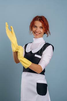 Maid wearing gloves, ready for cleaning photo