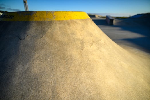 A Concrete Ramp at an Outdoor Skate Park. Concept Urban youth culture. photo