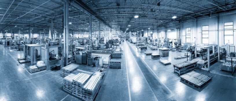 The expansive interior of a modern manufacturing facility with machinery and organization. photo
