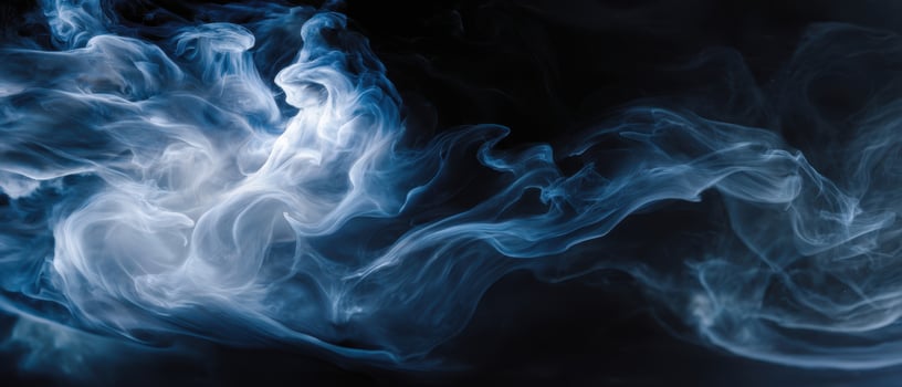 The ethereal dance of blue smoke against a dark background. photo