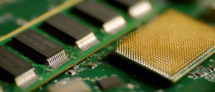 The close-up view of a microchip on a green circuit board. photo