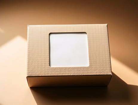 A white square in a cardboard box on a brown surface photo
