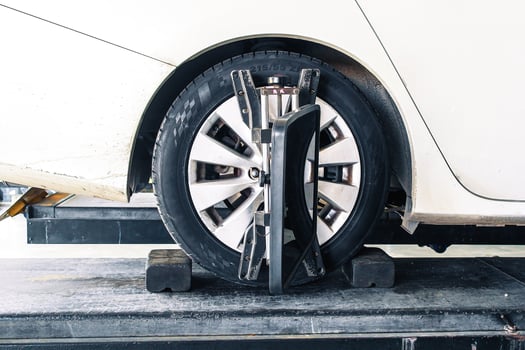 Wheel alignment or car alignment with radar sensor installing on rim, car maintenance service, automotive suspension repair. photo
