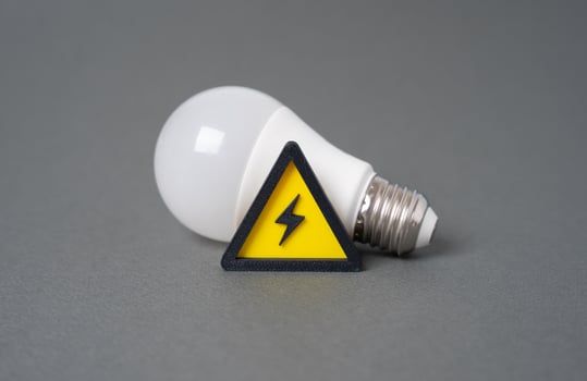 Light bulb and energy sign. Lack of electricity, energy crisis. Power outages disrupt systems. Energy demand. Alternative energy sources. photo