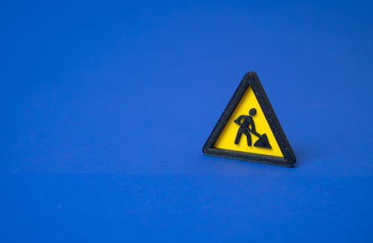 Sign men at work. Repairs and restoration work. Under construction. Road maintenance underway. Infrastructure upgrade ongoing. Temporary disruption expected. Utility servicing. photo