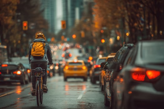 A person riding a bike on a busy city street photo