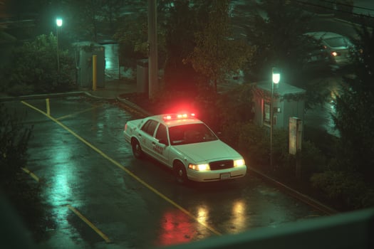 A police car parked in a parking lot at night photo