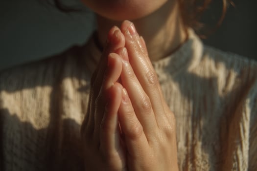 A woman is praying with her hands folded photo