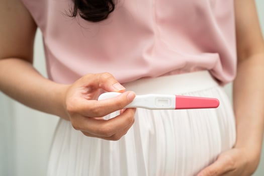 Asian holding pregnancy test for female of ovulation day, fetus, maternity, childbirth photo