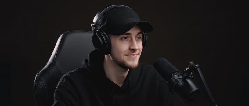 The young man with headphones and microphone in a streaming setup. photo