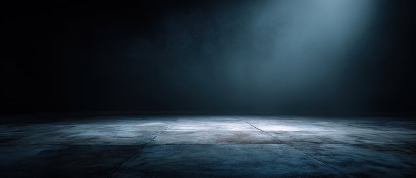 The dramatic spotlight illuminating an empty stage in a darkened space. photo