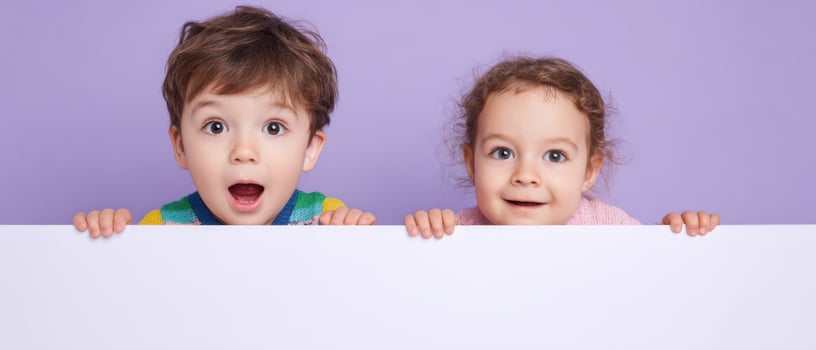 The surprised children holding a blank sign in a playful setting. photo