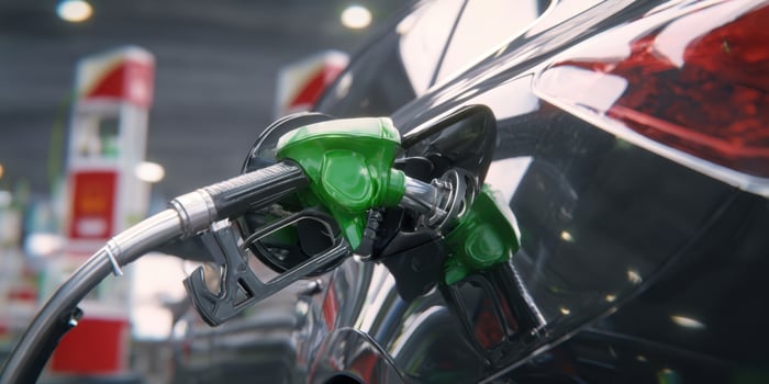 The sleek car being refueled at a modern gas station. photo