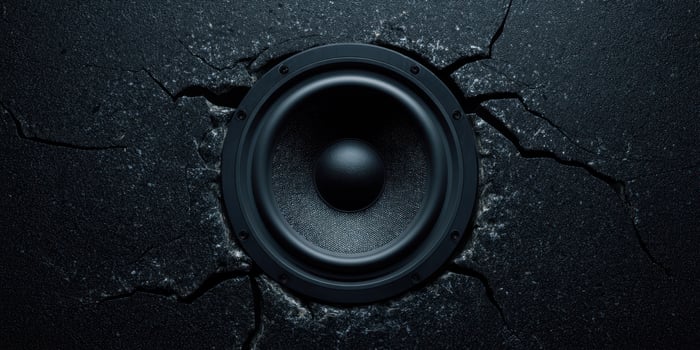 The powerful speaker emerging from a cracked surface creates striking visual impact. photo