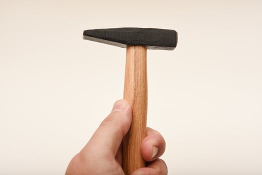 DIY and repair tool - wooden-handled hammer with dual-purpose head, white background. photo