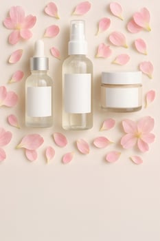 Skincare Bottles with Pink Flower Petals for Beauty and Skincare photo