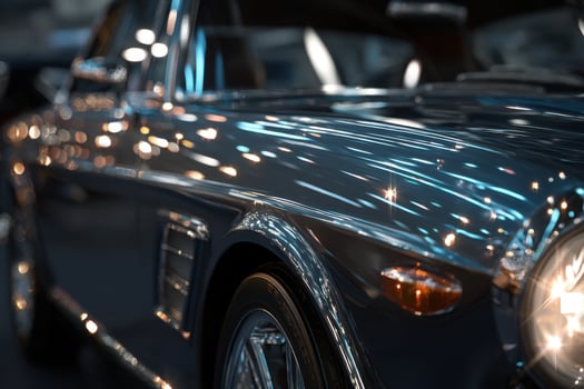 A close up of a classic car with its headlights on photo