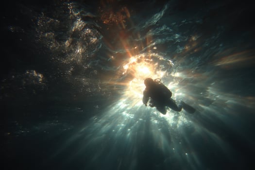 A person scuba diving in the ocean photo