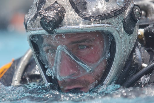 A man wearing a diving helmet and diving gear photo