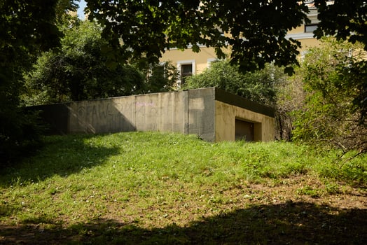A Modern Concrete Structure is Elegantly Surrounded by Beautiful Greenery and Nature photo