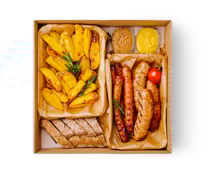 A takeout box contains juicy sausages alongside golden crispy potatoes and slices of fresh bread. Accompanying condiments add flavor to this hearty meal perfect for any time. photo